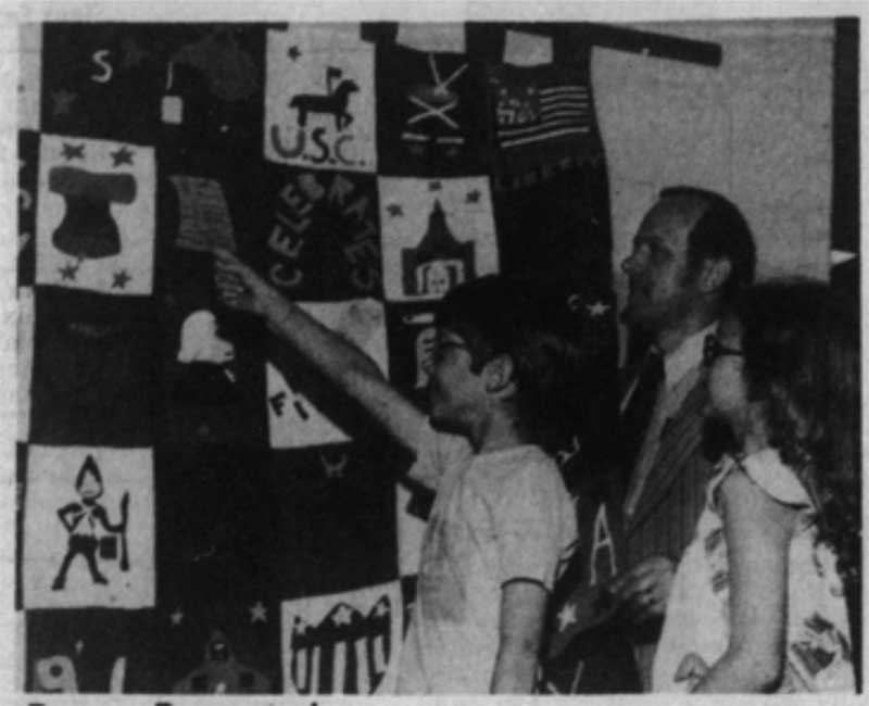 People looking at quilt